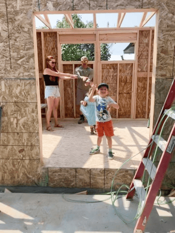 Example Co Construction Family building a wooden structure during a home renovation project.