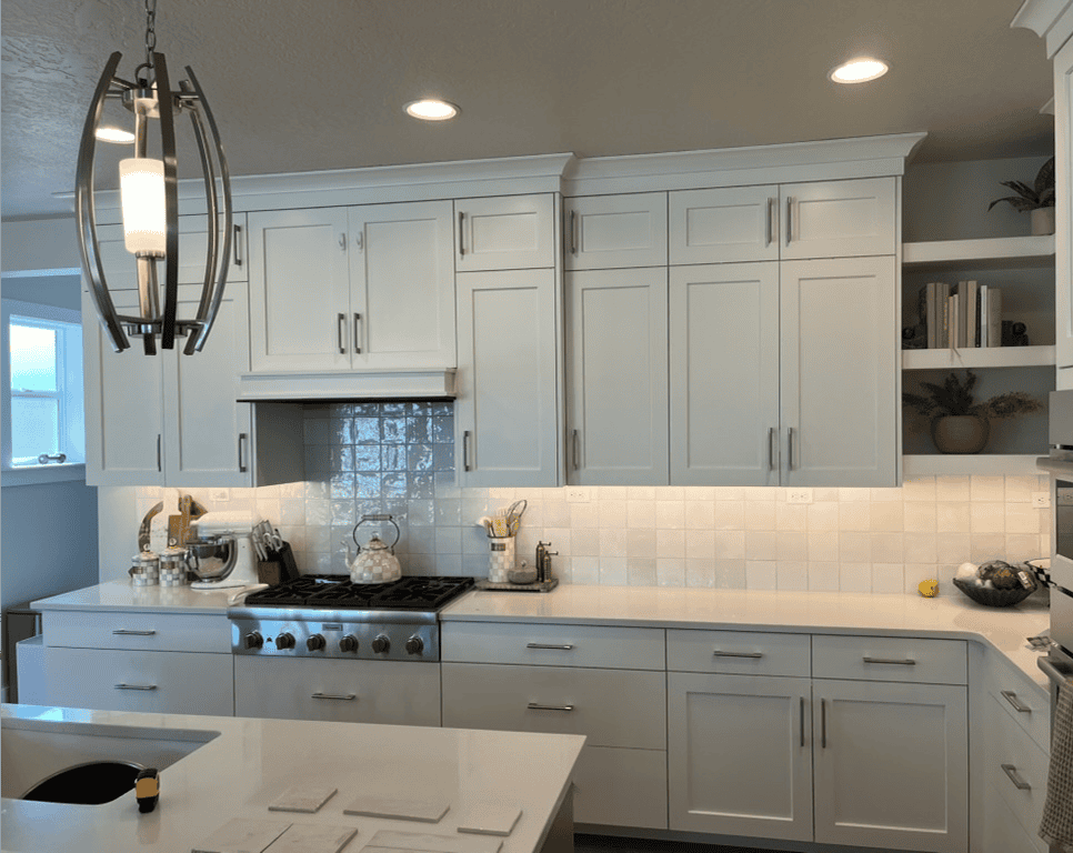 Modern Kitchen Design Bright white kitchen with modern cabinetry, pendant lighting, and a spacious countertop.