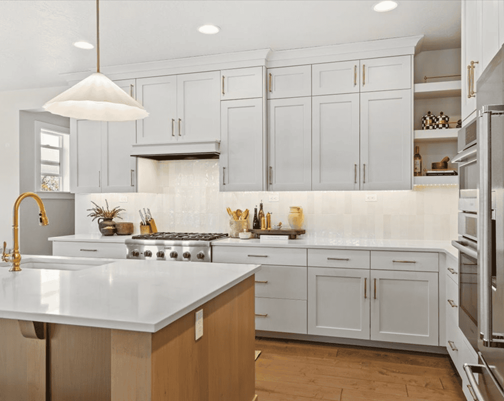 Modern White Kitchen Bright modern kitchen with white cabinets, gold fixtures, and a central island for cooking and prep.