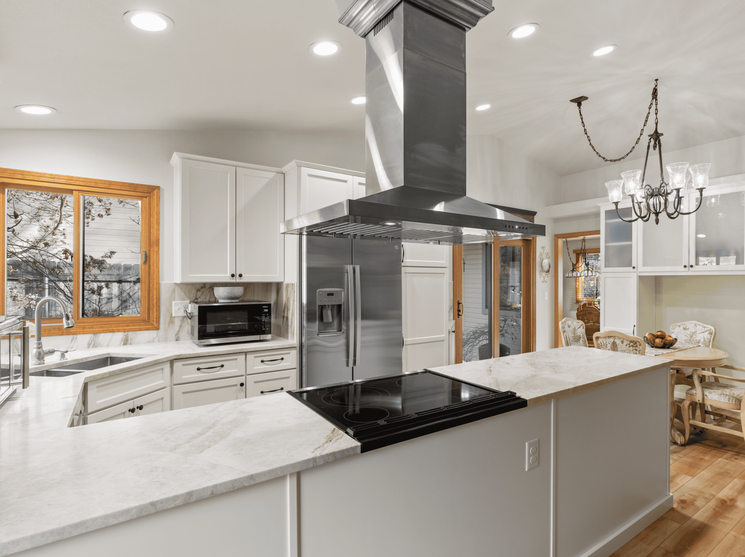 Modern Kitchen Design Spacious modern kitchen with white cabinets, stainless steel appliances, and a central island.