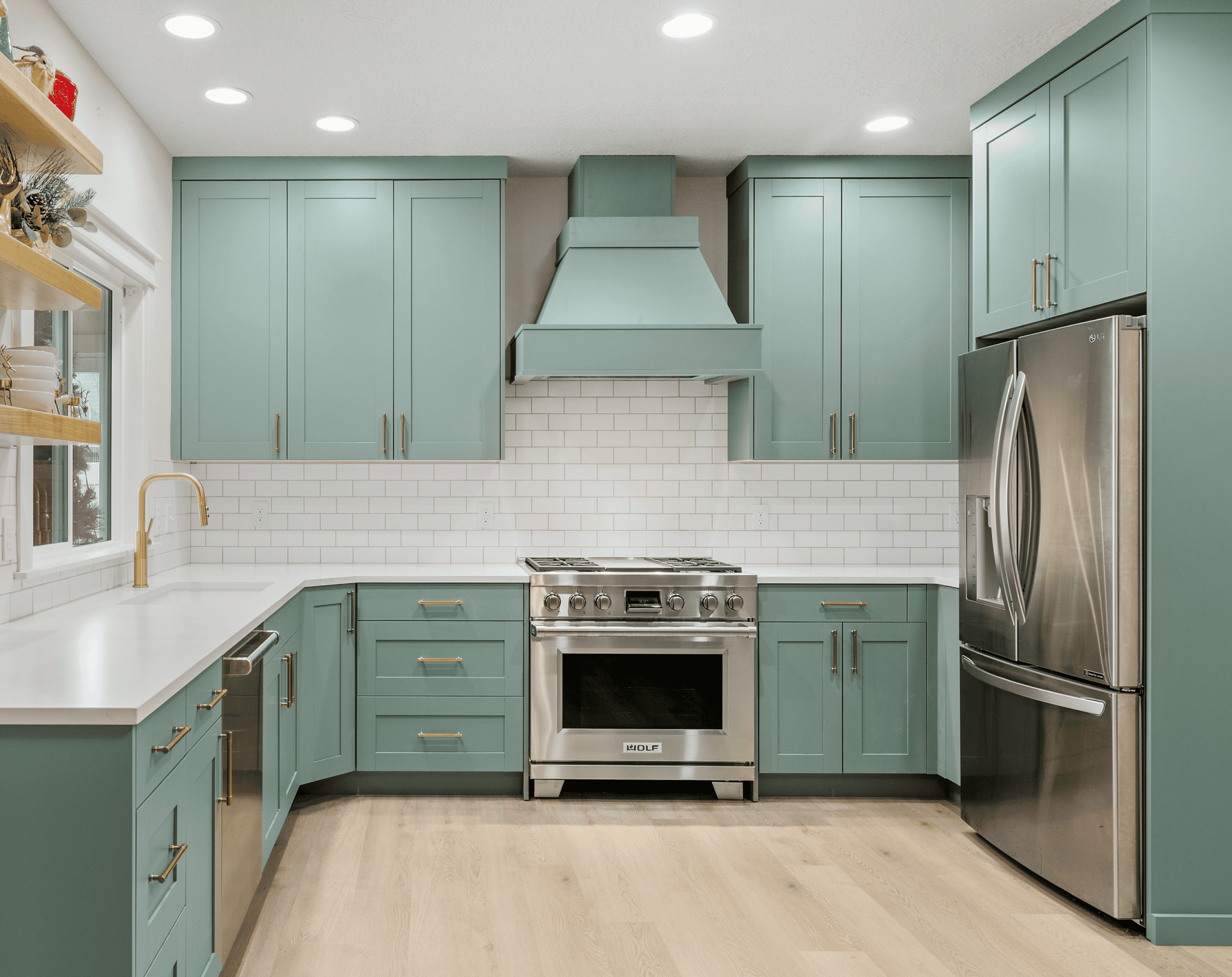 Modern Kitchen Design Contemporary kitchen with teal cabinets, stainless steel appliances, and white subway tile.