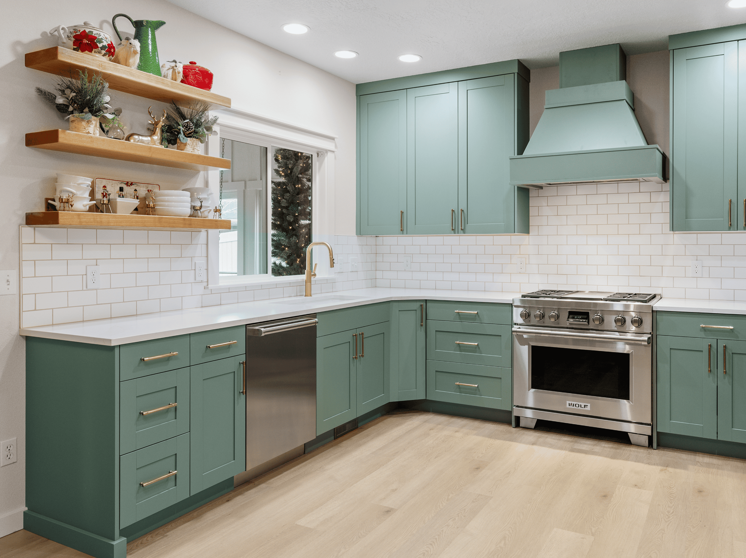Modern Kitchen Design Contemporary kitchen with teal cabinets, white subway tile backsplash, and stainless steel stove.