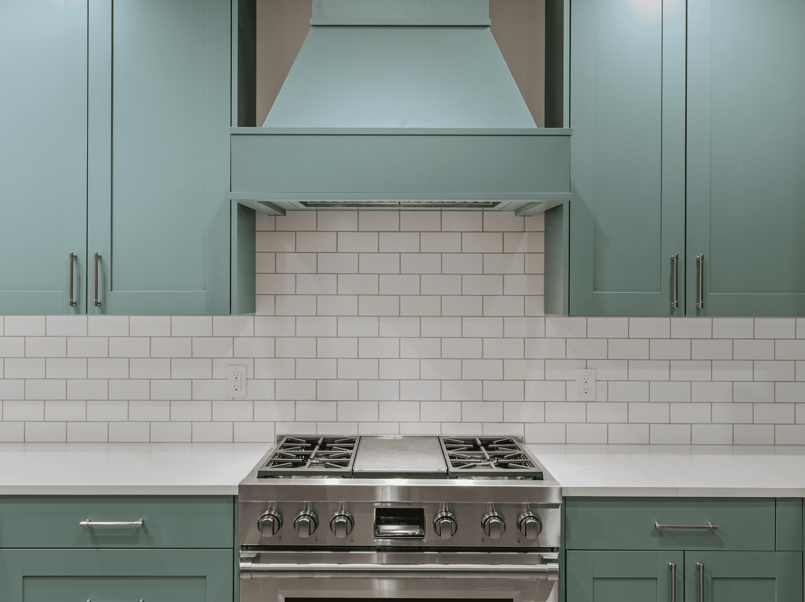 Modern Kitchen Design Contemporary kitchen with teal cabinets, white subway tile backsplash, and stainless steel stove.